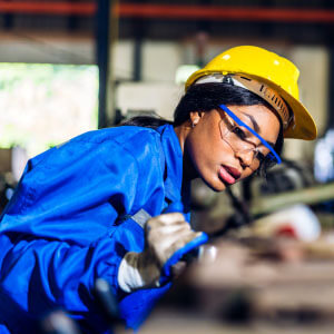 A woman working in a factory representing the manufacturing industry.