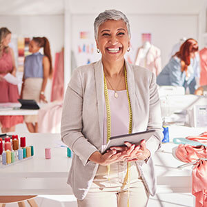 A woman standing in her studio representing the design industry.