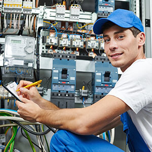 Man posing next to cords representing the electrical industry.