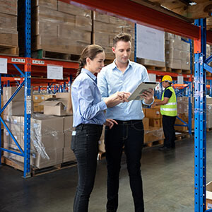 Two people in a warehouse representing the wholesale industry.