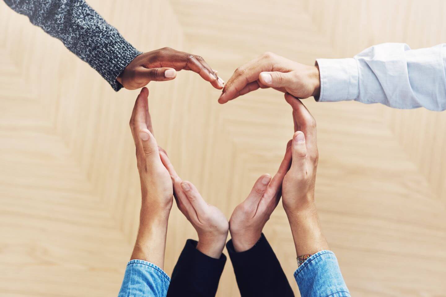 staff working for charity forming heart with hands