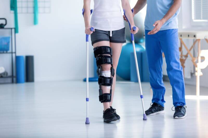 man in physical rehabilitation after work injury, covered by workers comp claim 