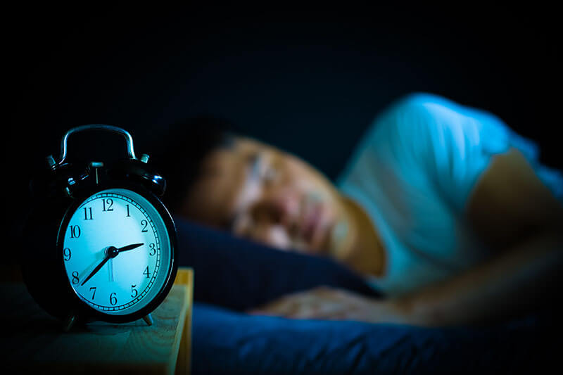 Sleeping person with disrupted circadian cycle