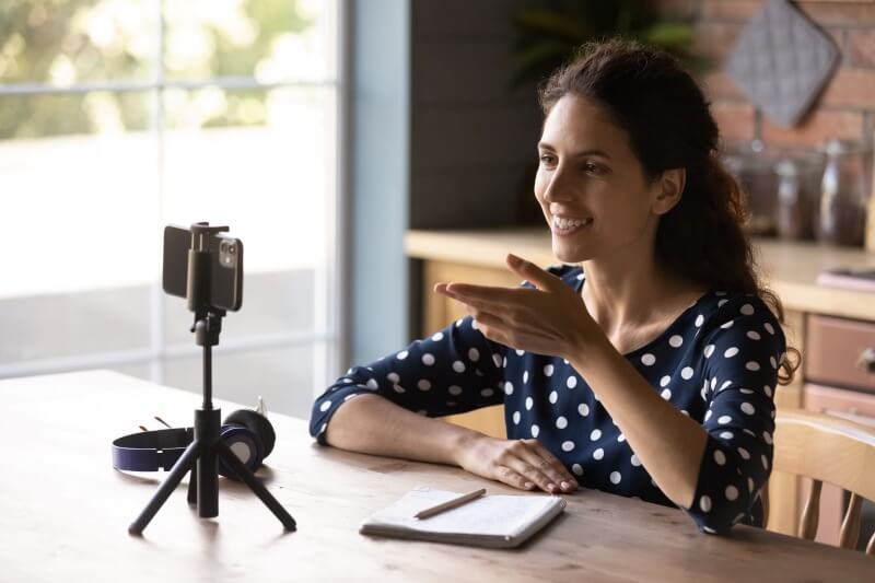 woman interviewing using a tripod to position camera at eye level