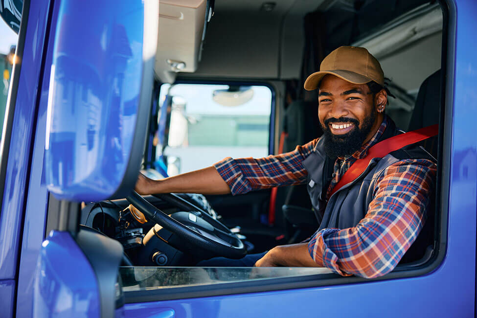 Smiling truck driver transporting a shipment