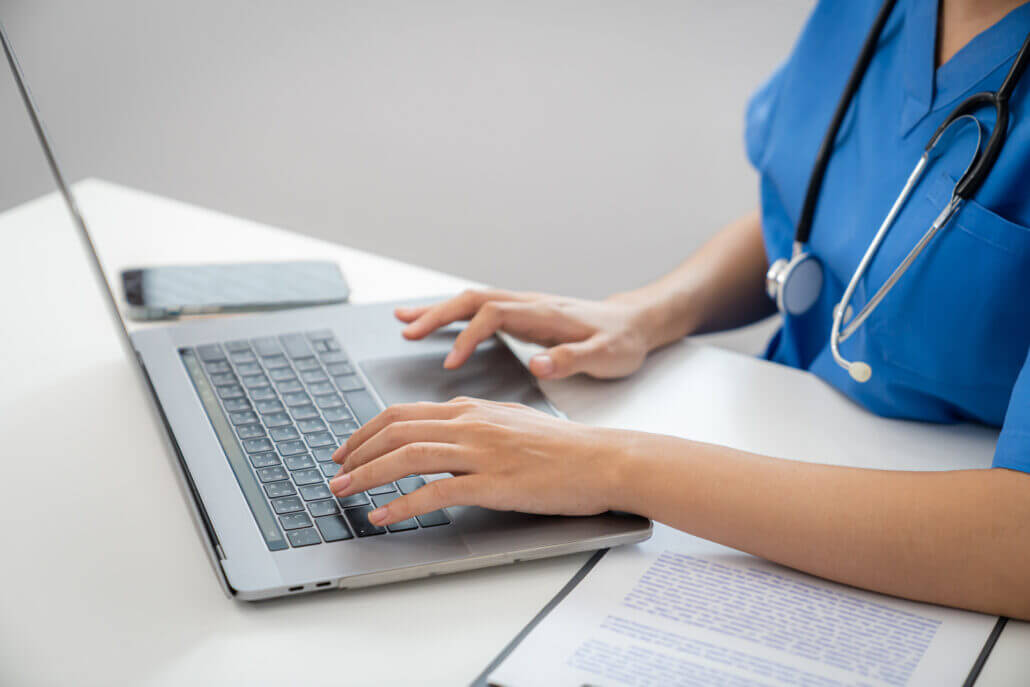 Close up of a nurse on a laptop