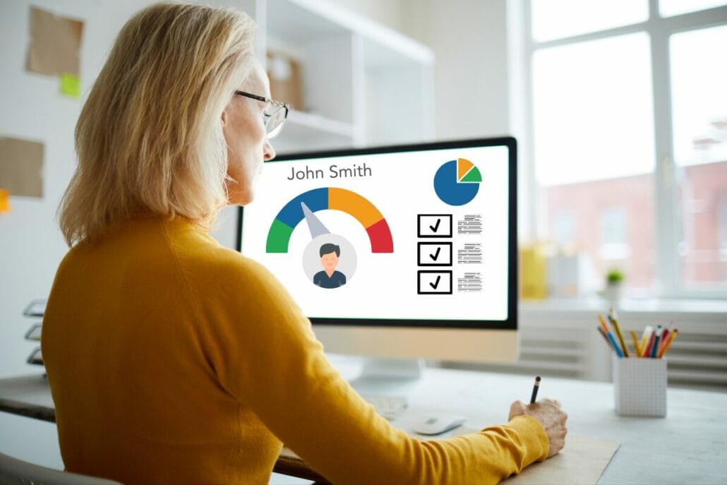 A woman in an office using software to evaluate performance issues and successes of an employee