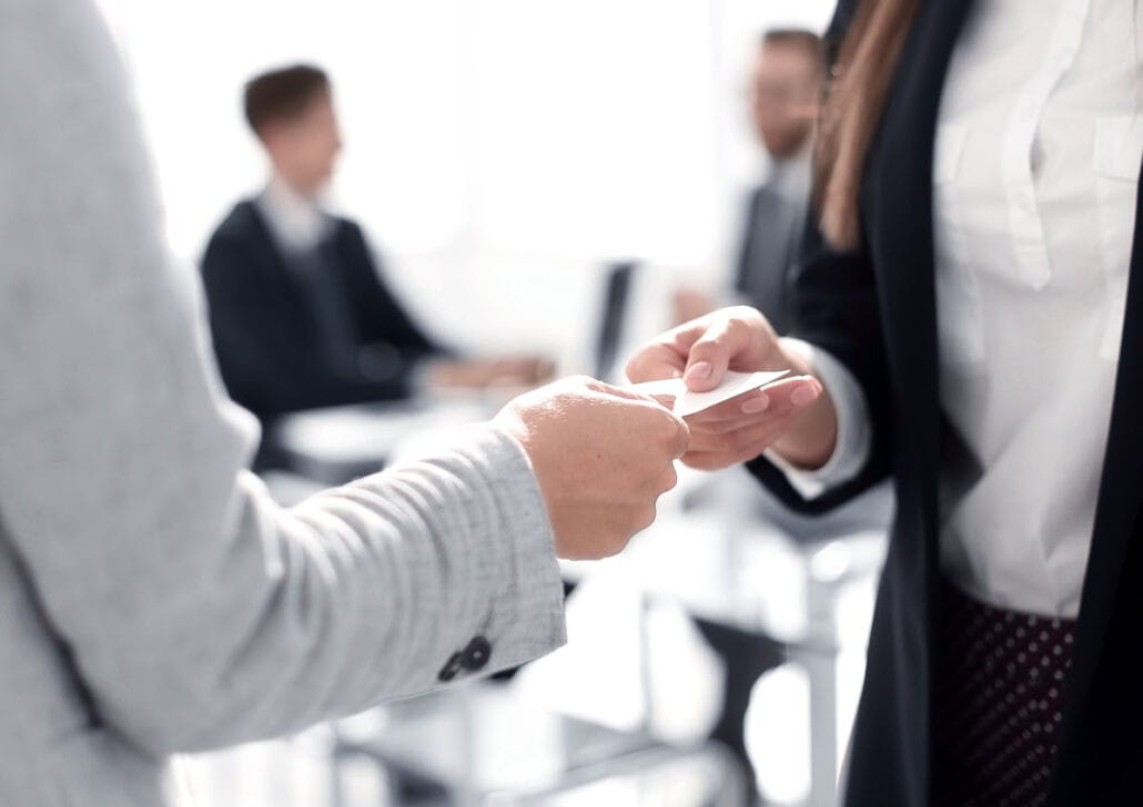 People exchanging business cards at a networking event