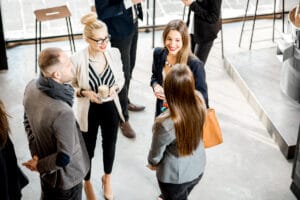 Professionals engaging in small talk at a business networking event