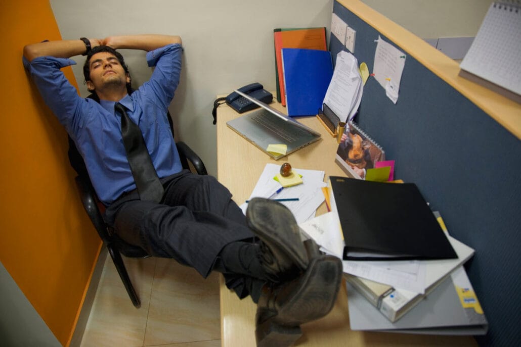 A man in an office being unproductive representing unclear goals leading to most performance issues