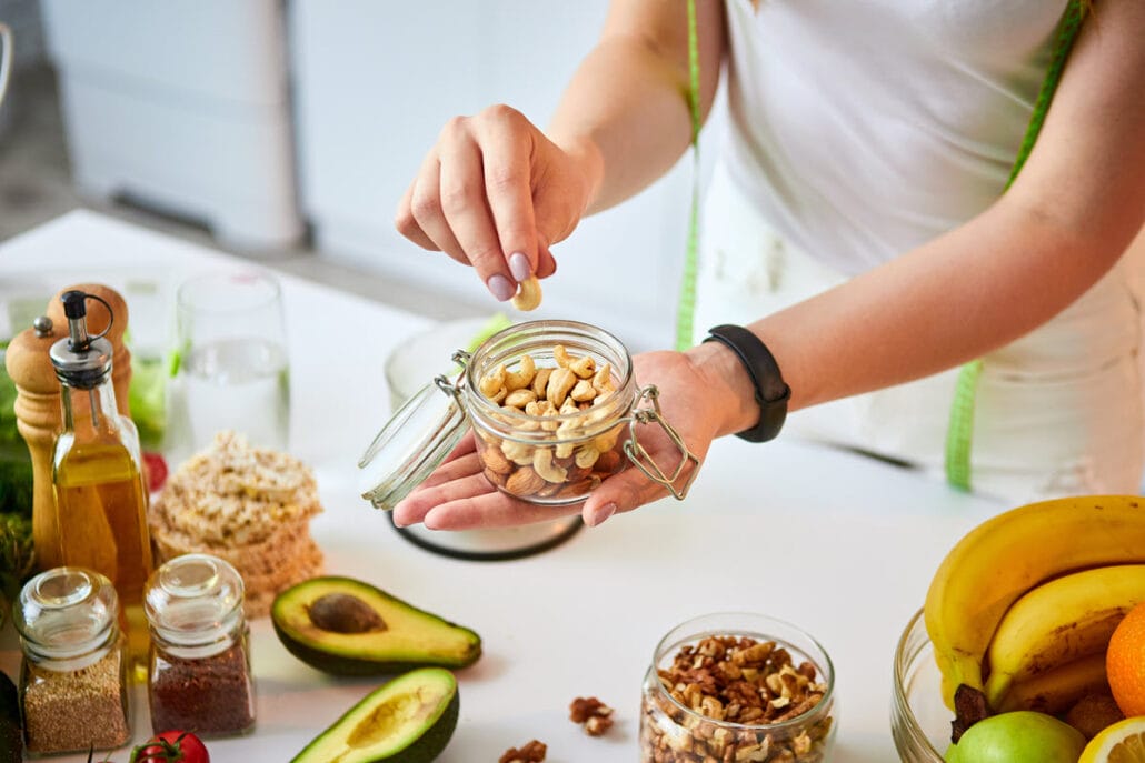 A woman preparing healthy snacks for work