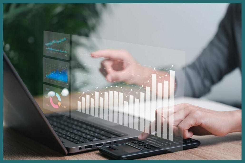 A close up of a man sitting at a desk, analyzing data and charts from various digital marketing channels on a laptop